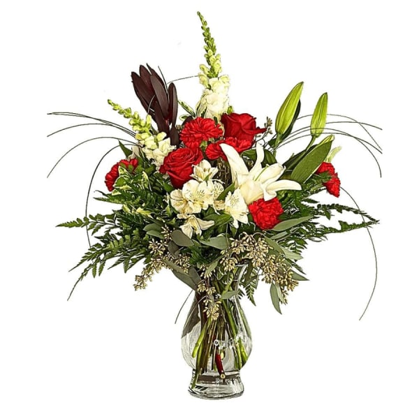 Red roses and white lilies in a clear glass vase