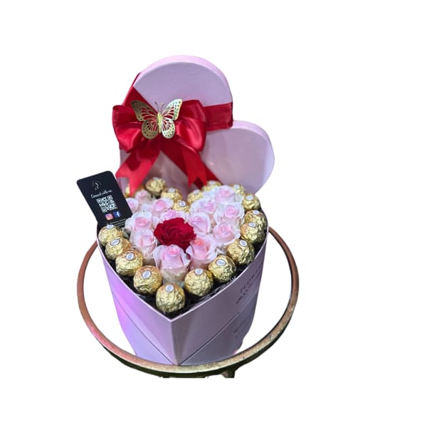 Heart-shaped box with pink roses and chocolates, topped with a red bow