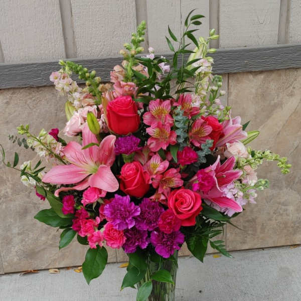 Pink and magenta mixed bouquet in a clear glass vase