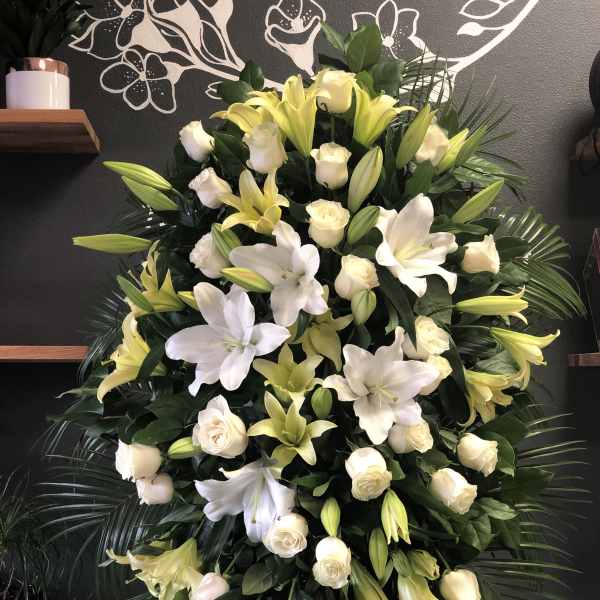 Large standing floral spray with white lilies and cream roses