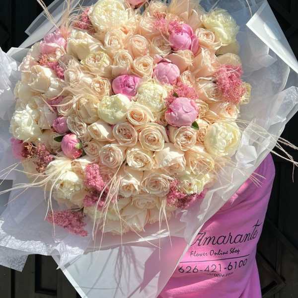 Large bouquet of blush and cream roses with pink accents