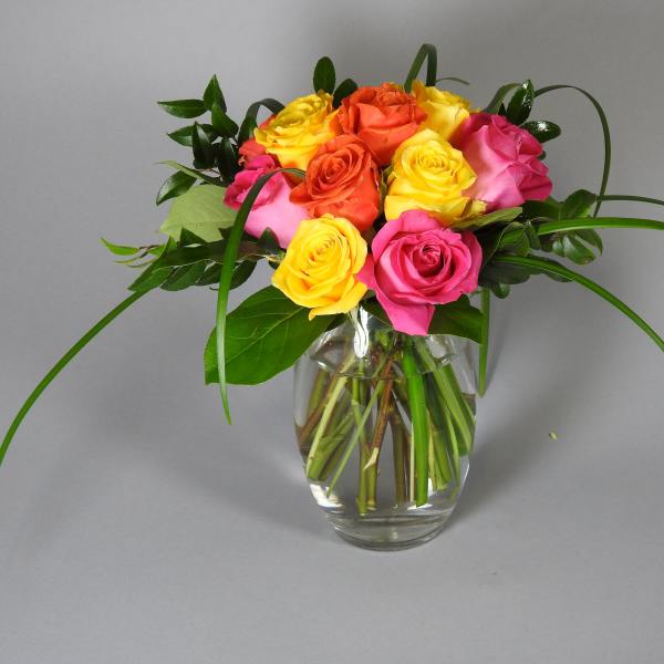Bouquet of multicolored roses in a clear glass vase