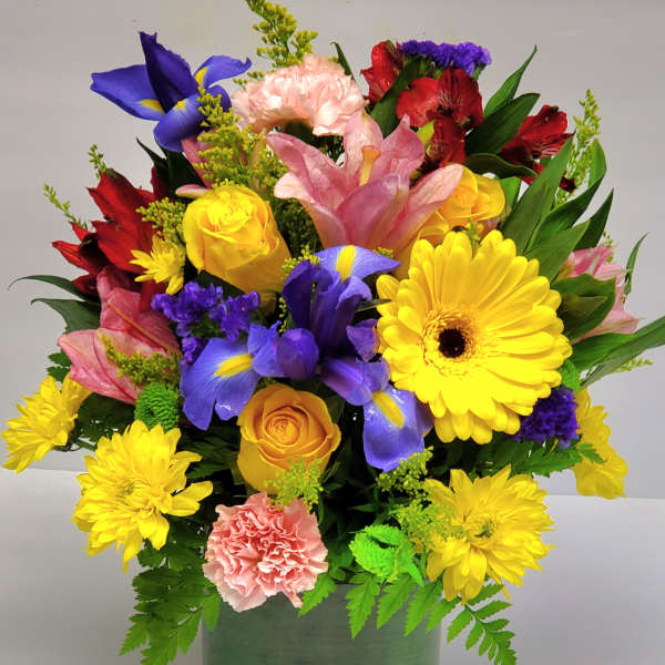 Colorful mixed bouquet in a green square vase