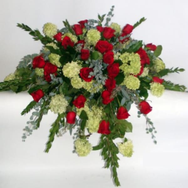 Large bouquet of red roses and pale green flowers on a white background