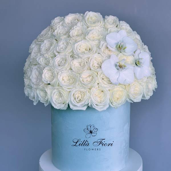White rose arrangement in a light blue hat box with white orchids