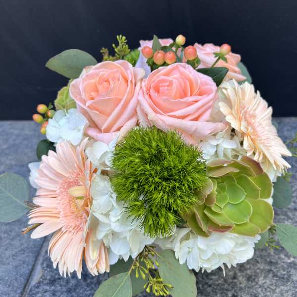 Bouquet of peach roses, pale gerbera daisies, and white hydrangeas