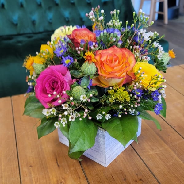 Colorful rose bouquet in a white square box