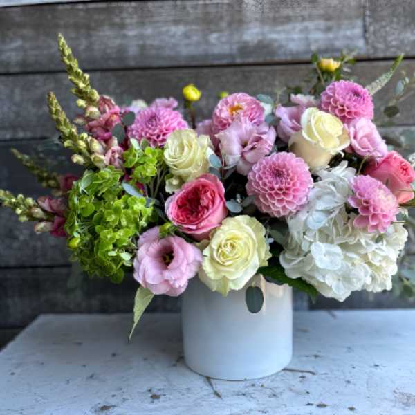 Pink and white mixed bouquet in a white vase