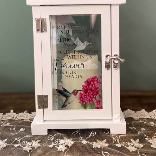 White memorial lantern with a candle and floral print