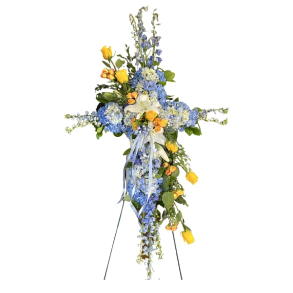 Standing floral cross with blue and yellow flowers on an easel