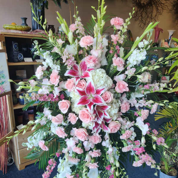 Large pink and white floral standing spray with lilies and roses