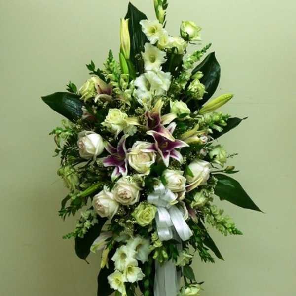 Tall white and purple floral standing spray with ribbon