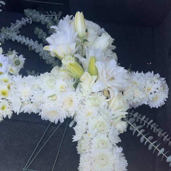 White floral cross arrangement with lilies and chrysanthemums