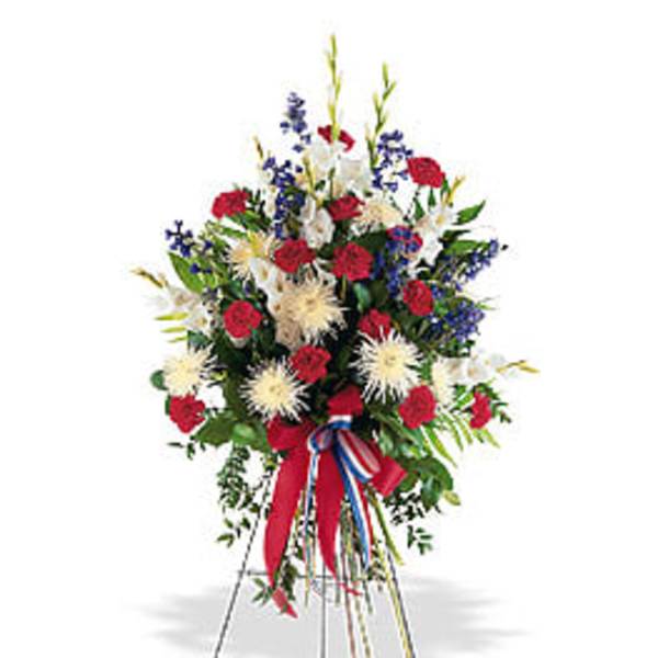 Standing floral spray with red, white, and blue flowers on an easel