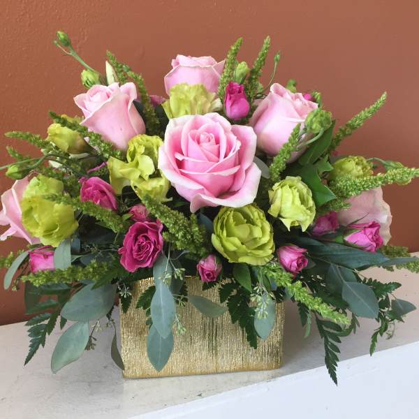 Pink and green rose bouquet in a gold rectangular container