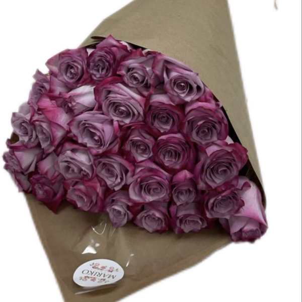 Bouquet of purple roses wrapped in brown paper