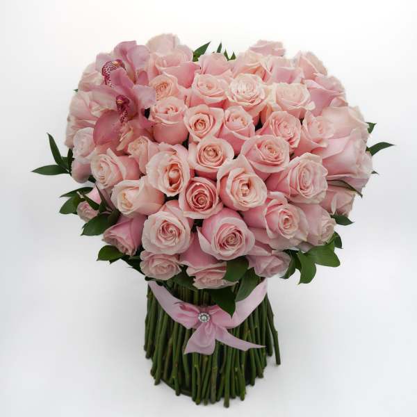 Bouquet of pale pink roses with pink orchids and a pink ribbon wrap