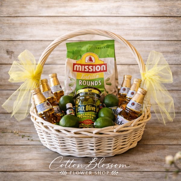 Gift basket with tortilla rounds, mini bottles, limes, and a jar of jalapeño peppers