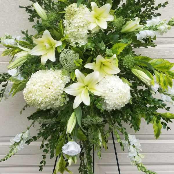 White lilies and hydrangeas in a large standing spray