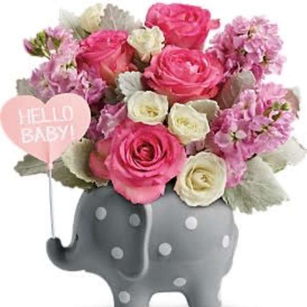 Pink and white roses in a gray elephant planter with a heart balloon