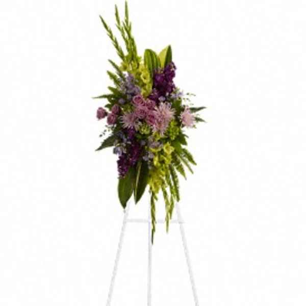 Tall purple and green floral standing spray on an easel