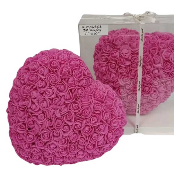 Heart-shaped arrangement of pink artificial roses with one displayed in a clear gift box