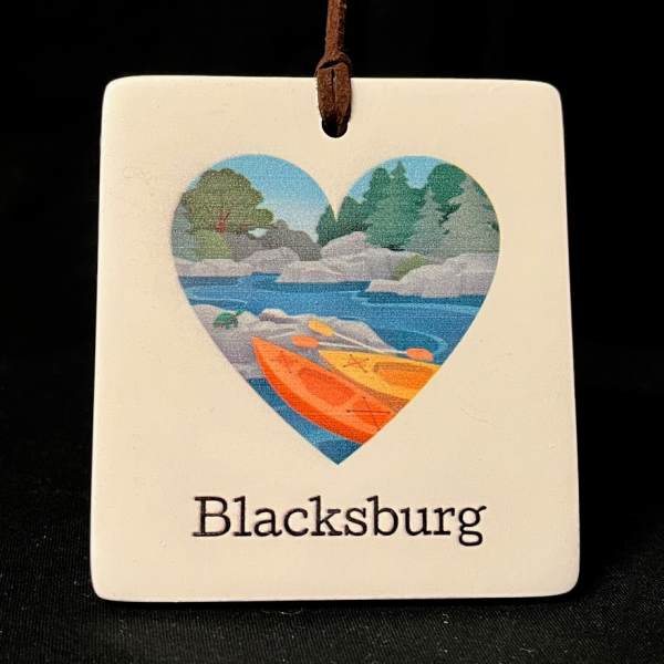 Heart-shaped ornament with a kayak scene and the word Blacksburg