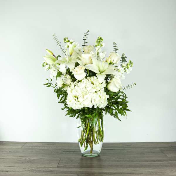 White floral arrangement in a clear glass vase