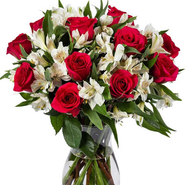 Red roses and white alstroemeria in a clear glass vase