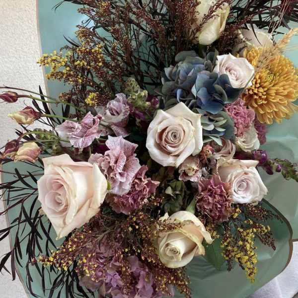 Bouquet of pale roses, hydrangea, and yellow chrysanthemum blooms