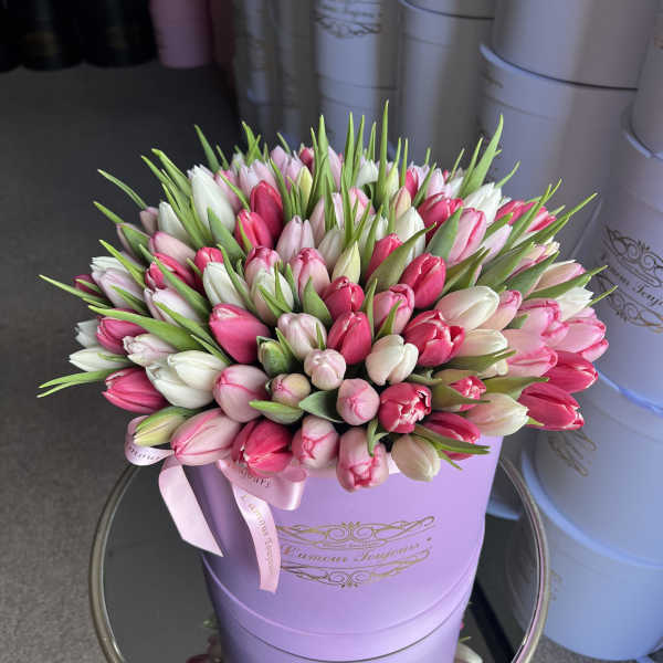 Bouquet of pink and white tulips in a lavender hat box