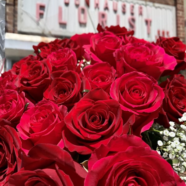 Bouquet of red roses with small white filler flowers