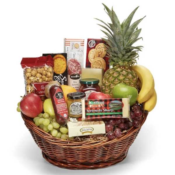 Fruit and snack gift basket with pineapple, bananas, grapes, and packaged cheeses and crackers
