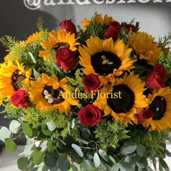 Sunflower and red rose arrangement in a green vase