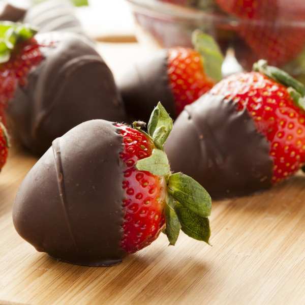 Chocolate-dipped strawberries on a wooden surface