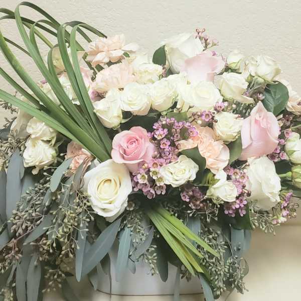 Bouquet of white and blush roses with small purple flowers