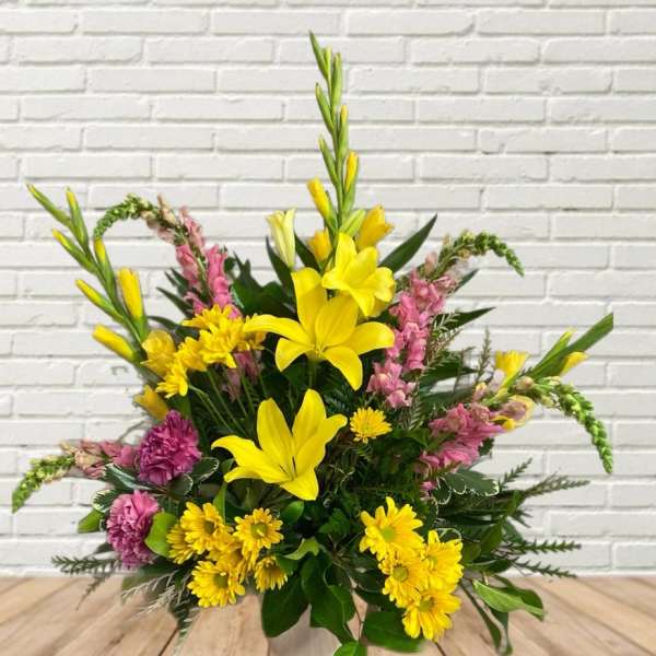 Yellow lilies and pink flowers in a mixed bouquet