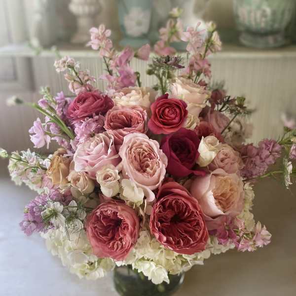 Pink and cream rose bouquet in a glass vase