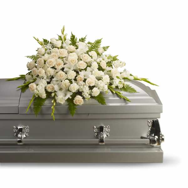 White floral spray on a gray casket