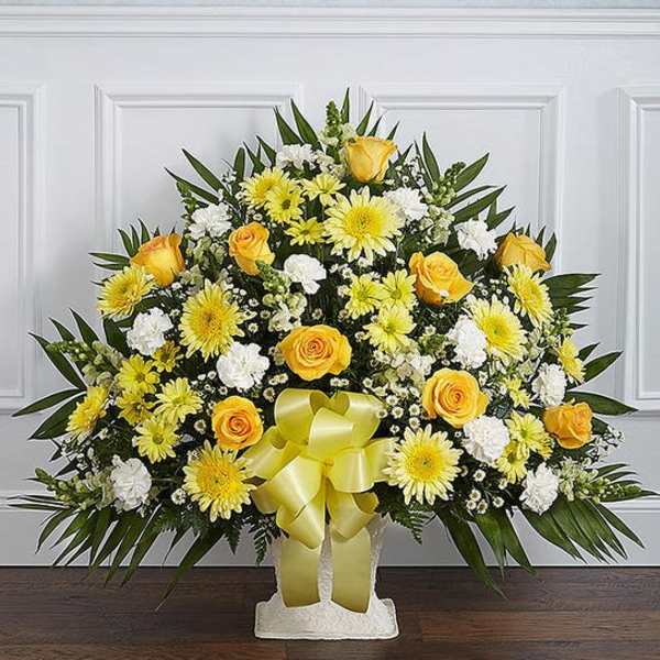 Yellow and white floral standing spray with a ribbon bow