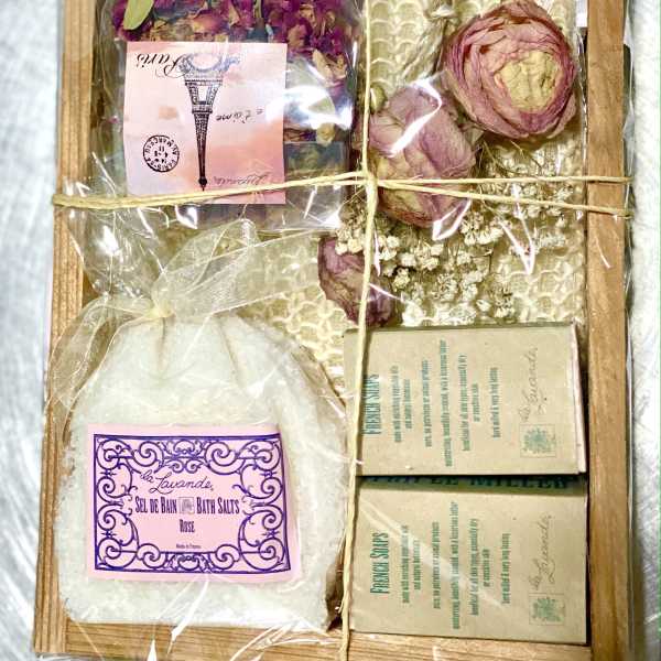 Gift box with dried flower petals, bath salts, and soap bars