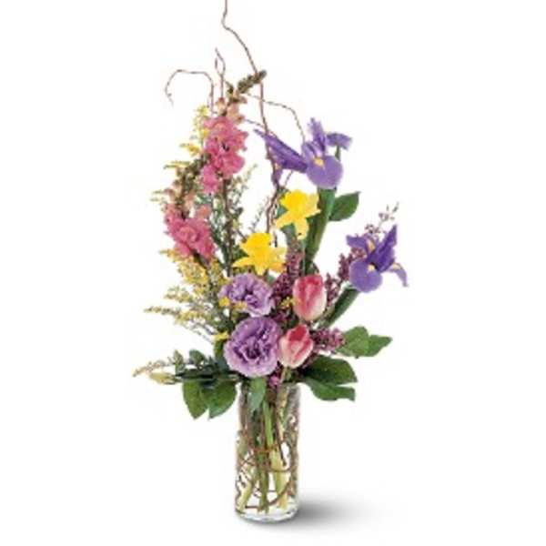 Tall mixed bouquet in a clear glass vase with purple, pink, and yellow flowers