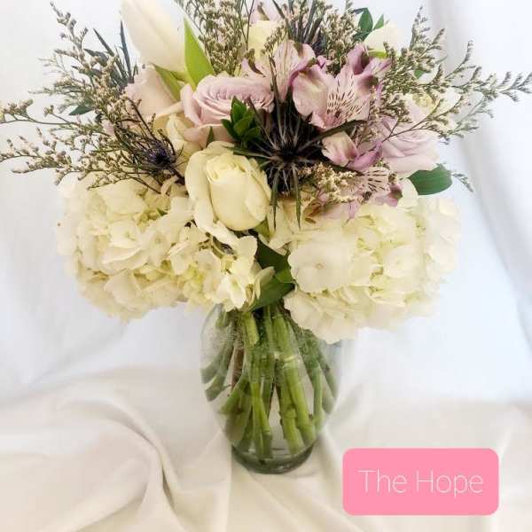 Bouquet of white and blush flowers in a glass vase