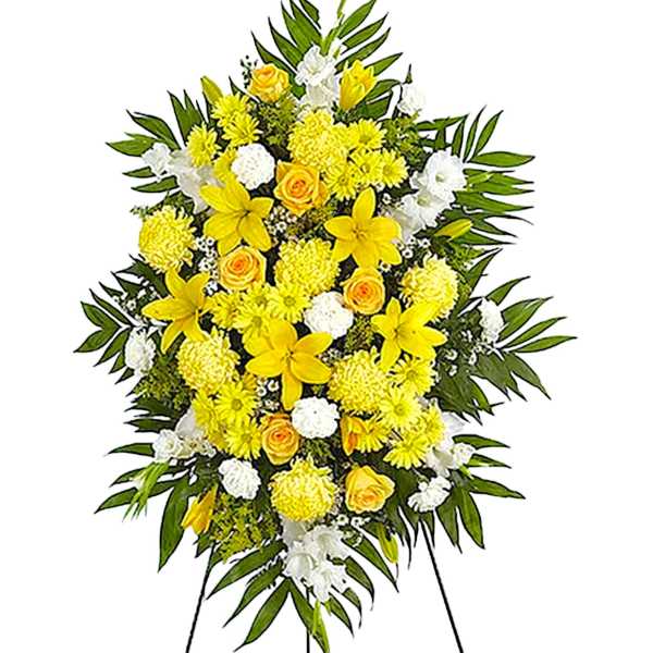 Yellow and white funeral spray on a standing easel