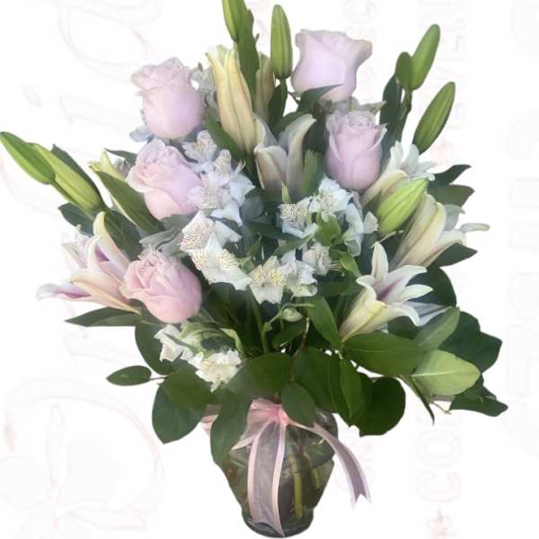 Bouquet of pink roses and white lilies in a glass vase