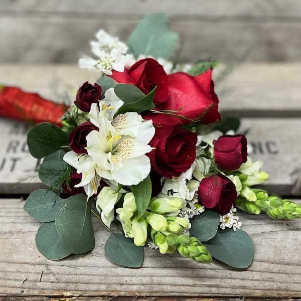 Bouquet of red roses and white flowers with eucalyptus