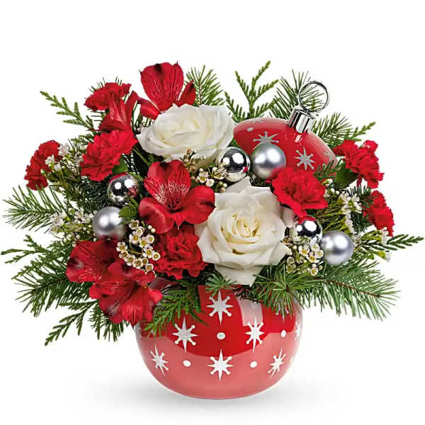 Red and white floral arrangement in a decorated red vase