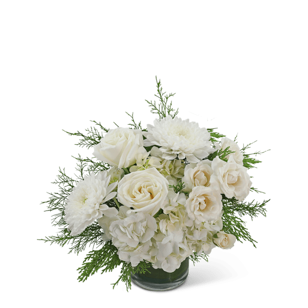 White roses and chrysanthemums in a glass vase with greenery