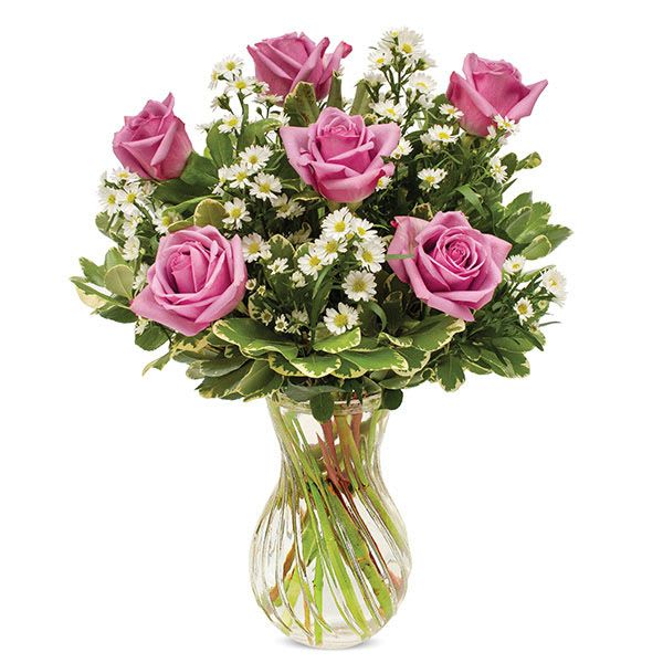 Pink roses and white daisies in a clear glass vase