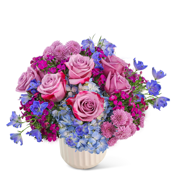 Pink roses and blue flowers arranged in a white vase